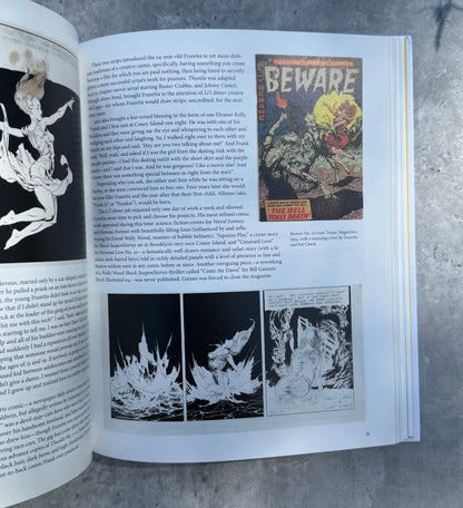 Open book with illustrations and text on a textured surface